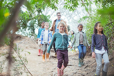 A group of children walking on the beach